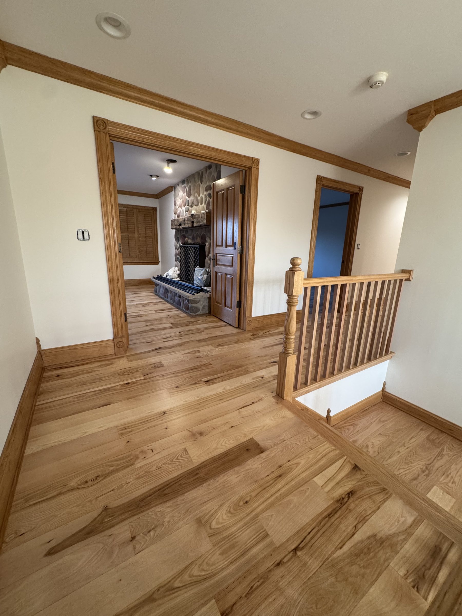 Upper hallway with hickory floors and matching railing